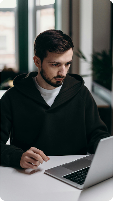 Person using a laptop to manage trading account